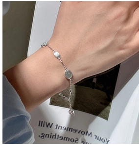 Detail of S925 sterling silver bracelet with textured oval discs worn on the wrist