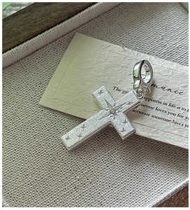 Macro view of vintage S925 sterling silver cross pendant with star engraving and gemstone