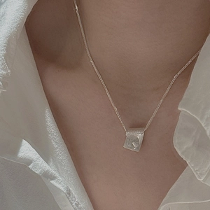 S925 sterling silver necklace with textured square moon pendant on woman's neck