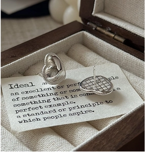 Macro view of S925 sterling silver puffed heart earrings with vintage texture and hallmark