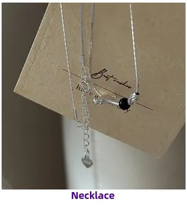 Detailed close-up of S925 sterling silver chain with black bead and heart-shaped logo tag