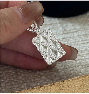 Macro view of S925 sterling silver geometric rhombic pendant with beaded edge detail