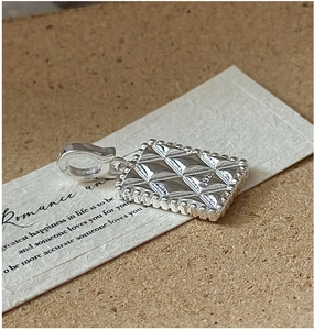Close-up of S925 sterling silver rectangular pendant with quilted diamond texture pattern