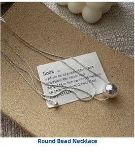 Detail of S925 silver minimalist long ball necklace with adjustable bead clasp