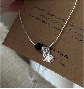 Detail of S925 silver necklace with black agate bead and irregular heart pendant