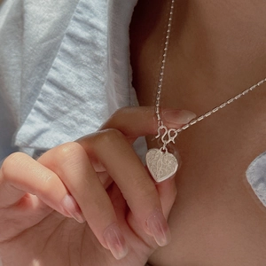 S925 sterling silver heart necklace with textured pattern on a beaded chain for women