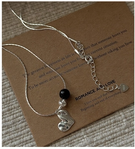 Detail of S925 sterling silver stamp on vintage heart necklace with black agate bead