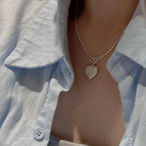 S925 sterling silver heart necklace with vintage texture on ball chain worn by model