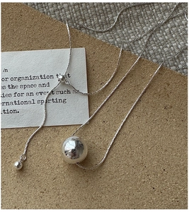 Macro detail of S925 silver adjustable pull-chain necklace with polished round bead