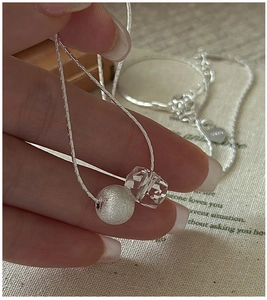 Macro shot of S925 sterling silver snake chain with matte bead and crystal pendant