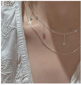 Gros plan d'un collier double épaisseur en argent S925 avec pampilles en zircone cubique