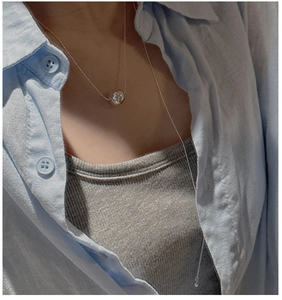 Detail view of a minimalist S925 silver beaded long necklace on a model's neck