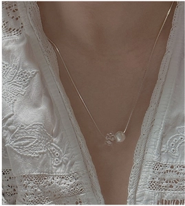 Macro detail of S925 sterling silver chain featuring frosted bead and crystal pendant