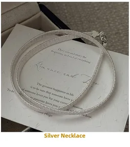 Close-up of S925 sterling silver blade chain necklace with heart lobster clasp and card