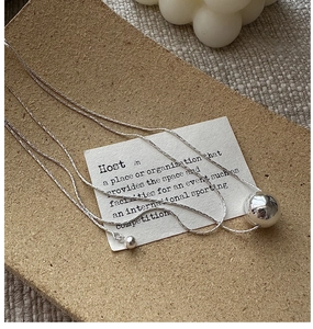 Detailed view of an S925 silver necklace with a large polished mirror ball pendant