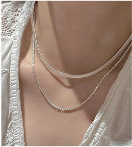 Close-up of S925 sterling silver layered necklace with flat snake chain and sparkle link