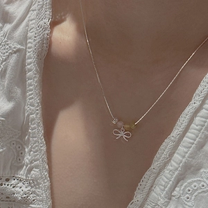 S925 sterling silver bow necklace featuring colorful beads worn on a model's neck