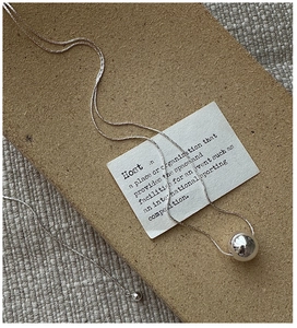 Detailed macro view of S925 silver minimalist long chain necklace with round bead pendant