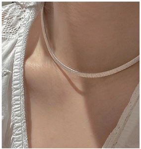 Close-up of S925 sterling silver minimalist choker with fine brushed metallic texture