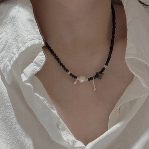 Minimalist S925 silver black onyx beaded necklace worn over a white cotton shirt