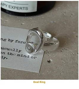 Macro shot of silver S925 geometric ring with clear round crystal and adjustable open band