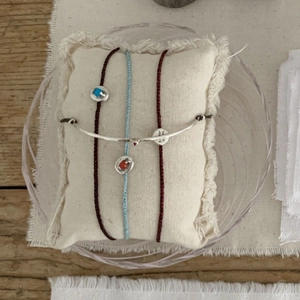 S925 silver retro branch cuff with red and blue gemstone cords on white fringe cushion