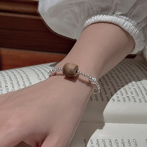 S925 sterling silver beaded bracelet with natural wood bead shown on a wrist