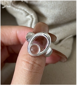 Macro detail of S925 sterling silver ring featuring a clear crystal in oval frame