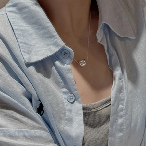 Minimalist S925 sterling silver long bead necklace on a model wearing a striped shirt