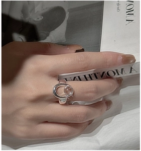 Detail of S925 silver ring with pink crystal bead worn on a finger in a chic setting