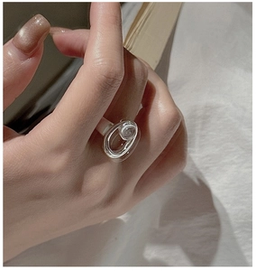 Detail of S925 sterling silver ring with white crystal on a finger in lifestyle setting