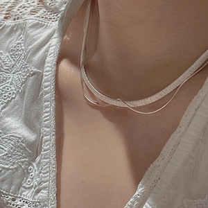 Elegant S925 sterling silver layered necklace with snake chain on white lace garment