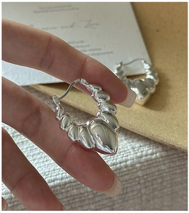Detailed view of S925 sterling silver hoop earrings with hollow croissant spiral texture