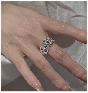 Close-up of S925 sterling silver beaded ring with three metallic balls on a model's finger