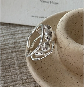 Macro shot of S925 sterling silver beaded ring with hallmark on ceramic vessel