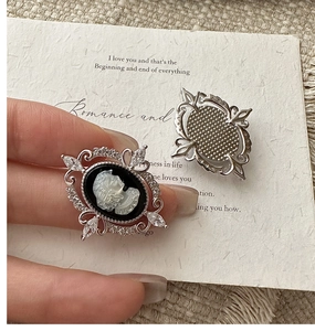 Detailed close-up of retro S925 silver cameo earrings with exquisite crystal inlay