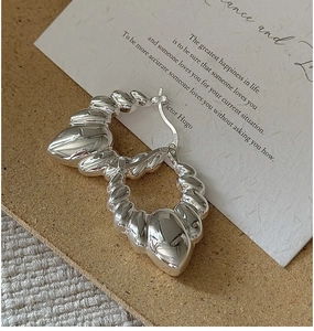 Close-up of S925 sterling silver croissant hoop earrings showing detailed twisted texture