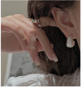Detail of matte silver S925 sterling silver earrings and matching fluid metal style ring