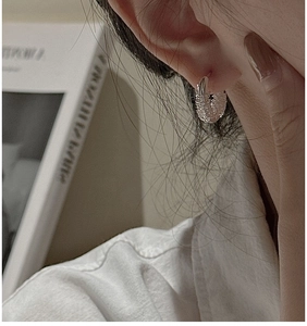 Macro shot of S925 sterling silver hoop earrings with irregular crinkle texture finish