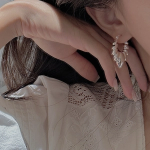 Elegant S925 sterling silver croissant hoop earrings with twisted texture worn by model