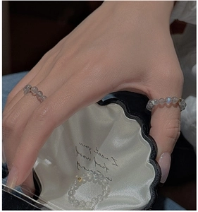 Close-up of S925 sterling silver beaded rings with grey moonstones in a shell box