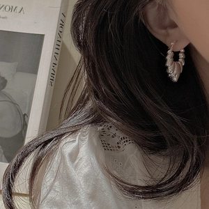 Elegant S925 sterling silver hoop earrings with hollow croissant texture on model