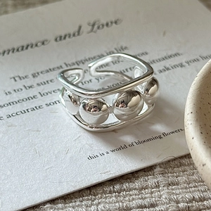 Minimalist S925 sterling silver beaded open ring on a poetic vintage paper background