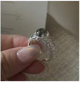 Dettaglio dell'anello in argento testurizzato con gemma scura e superficie martellata