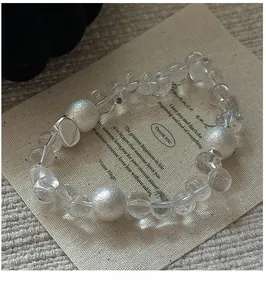 Close-up of S925 sterling silver beaded bracelet with clear crystals on canvas
