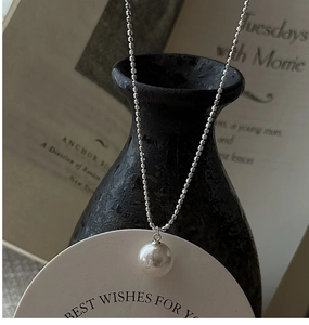 Detailed view of an elegant S925 silver pearl necklace with a polished round bead chain