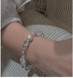 Detail of S925 silver beaded bracelet with faceted clear crystals and frosted beads