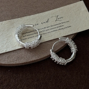 Retro S925 sterling silver woven hoop earrings with vintage texture on soft felt background