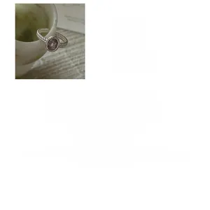 Macro detail of S925 sterling silver ring featuring oval rutilated quartz and twisted band