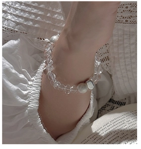 Close-up of S925 silver beaded bracelet with clear faceted crystals on a model wrist